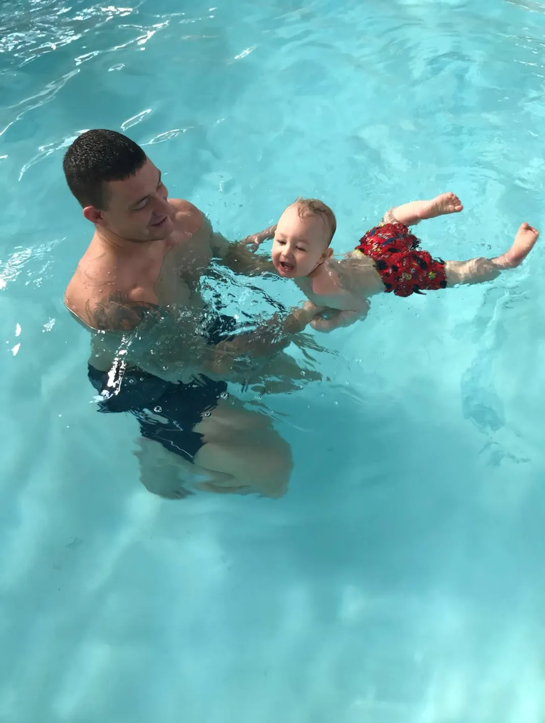 Christian and Dad in the pool — Christian's first proper swim with Dad holding him up.